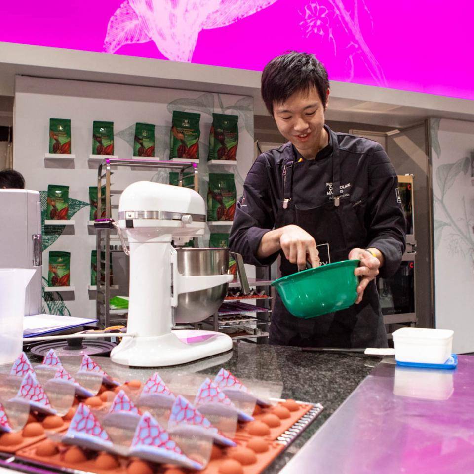 A chef-finalist works on his entry using a KitchenAid mixer