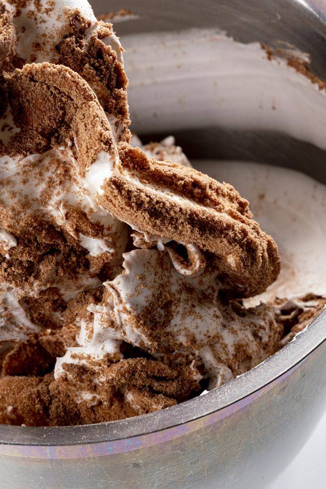 Cacao powder being folded into whipped egg whites