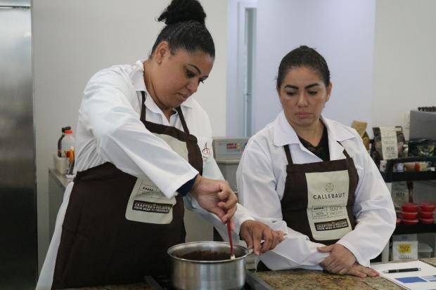 pessoas trabalhando com chocolate em bancada