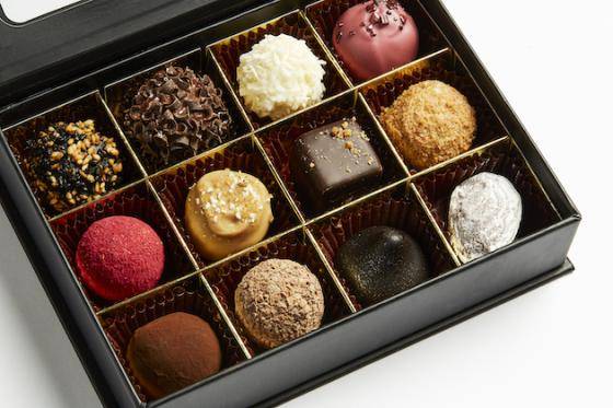 An open box displaying a varied assortment of chocolate confections